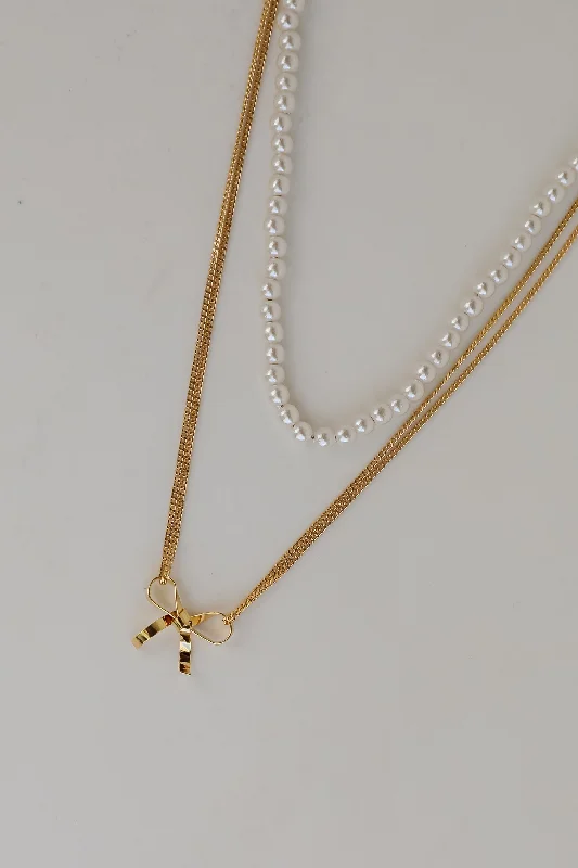 Shop Classic Women's Necklaces & Pendants with a Modern Twist-Allison Gold Pearl Bow Charm Layered Necklace Shop Classic Women's Necklaces & Pendants with a Modern Twist-Allison Gold Pearl Bow Charm Layered Necklace